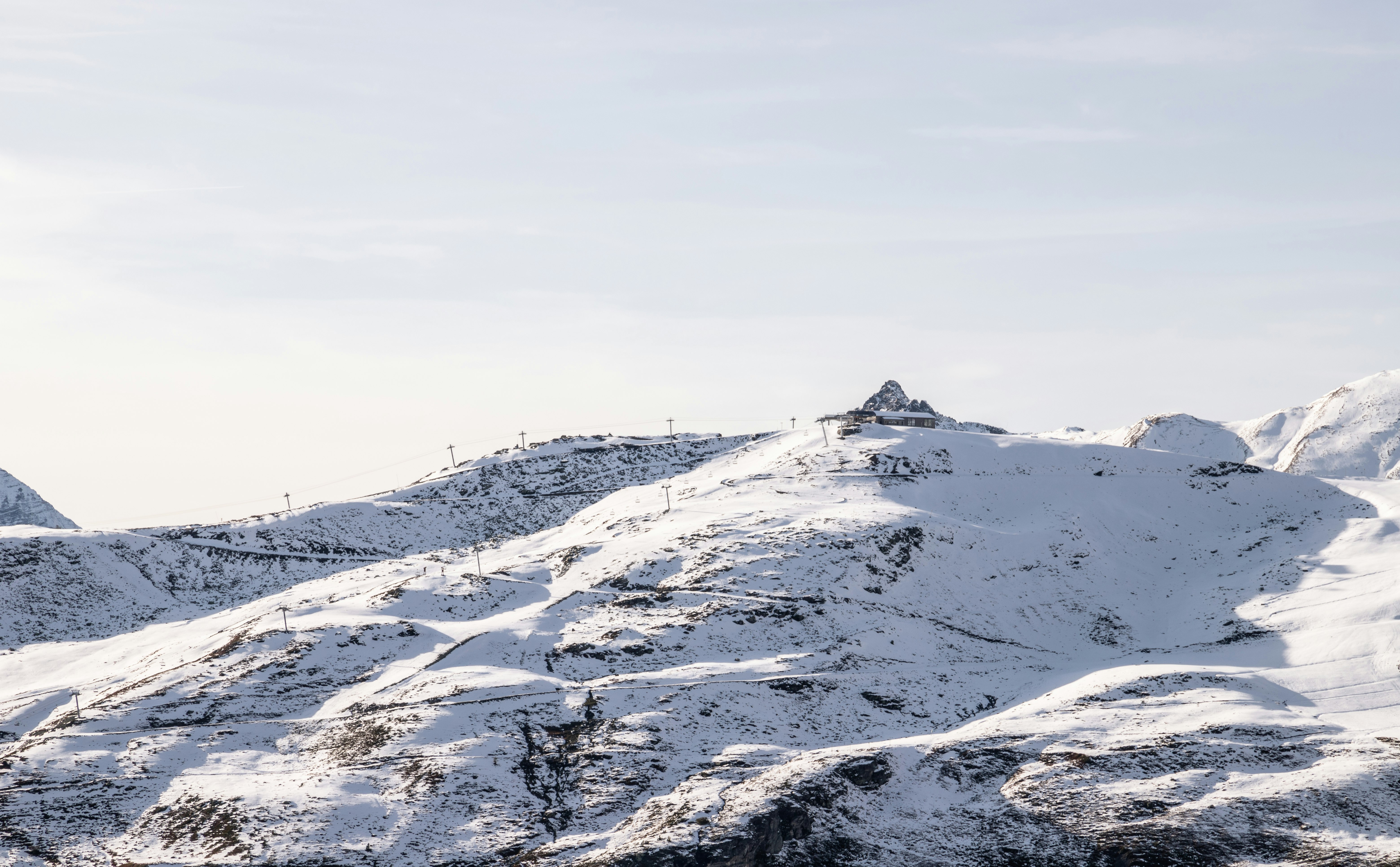 snow covered mountain under white sky during daytime